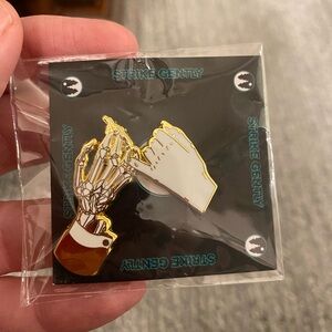 Strike Gently Gold and White Skeleton Handshake Enamel Pin